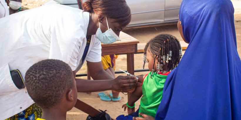 A health worker delivers TCV to a child during Burkina Faso's TCV introduction campaign. A new study examines the costs of the campaign.